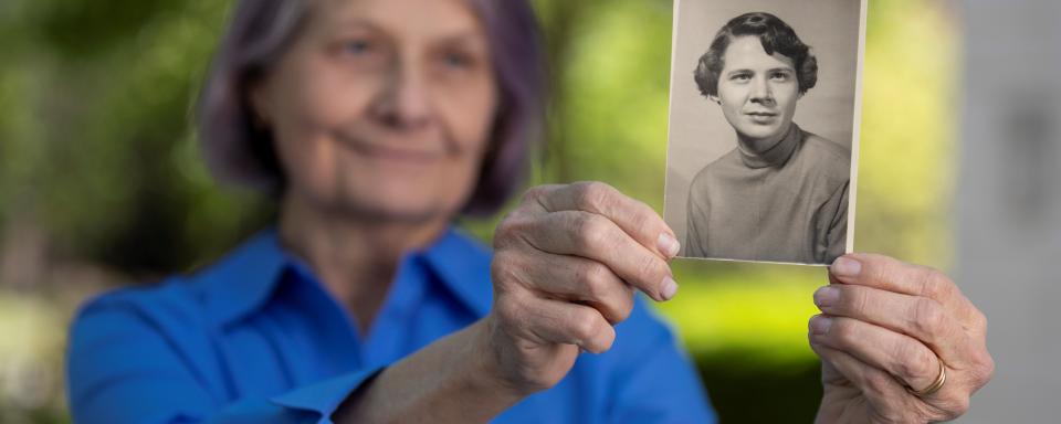 Patient holding black and white childhood photo